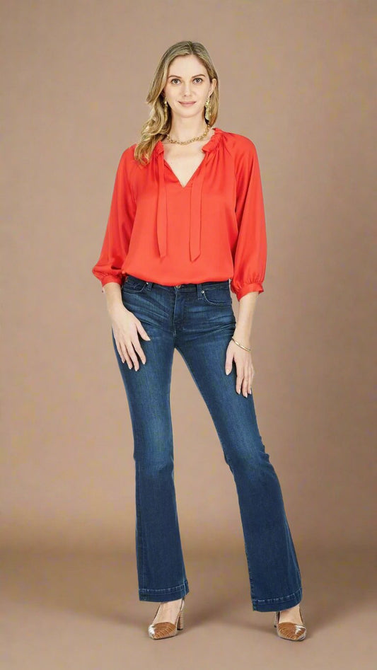 In a striking red hue, this 3/4 length sleeve blouse features pleated accents, a flowy fit, and an adjustable v-neckline open tie finish