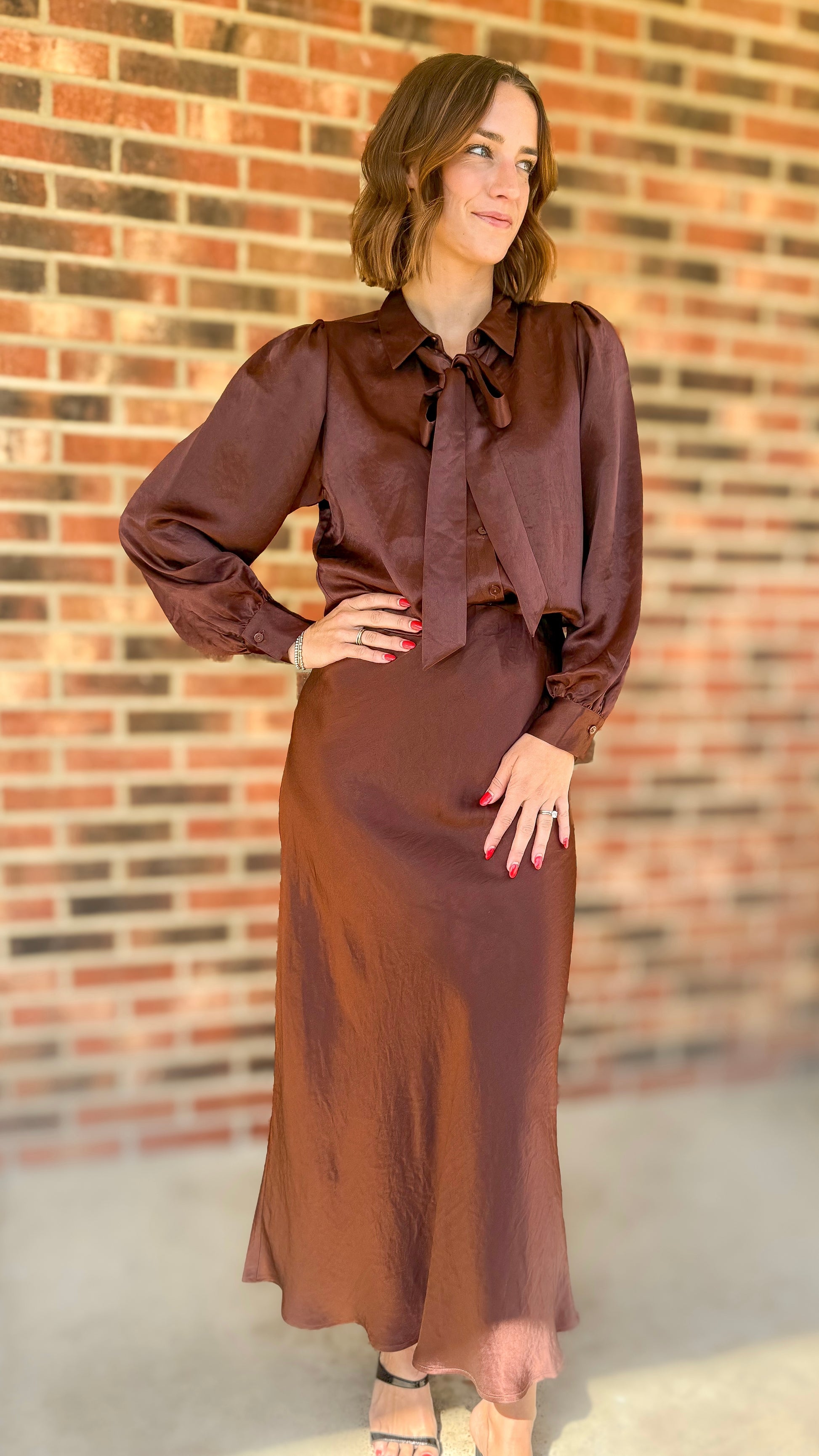 Esqualo long crushed satin quality chocolate brown skirt made from 100% acetate. The skirt features an elastic waistband which adds to its comfort.