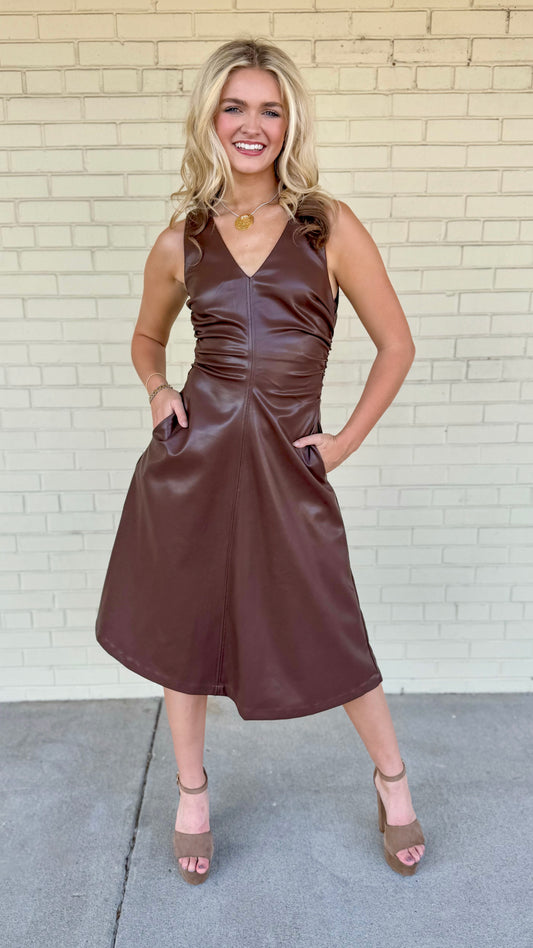 Faux leather V-neck midi dress, 
Ruched sides with center seam detail, 
Partially lined at upper bodice, Functional side pockets, Concealed center back zipper