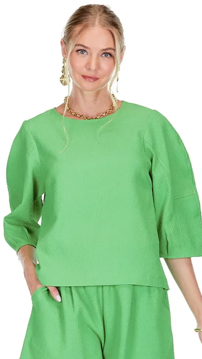 Textured green crewneck top with 3/4 length sleeves and keyhole back detail. Pair it with the matching shorts for an elevated look this spring, perfect for travel!